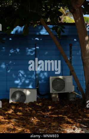 Old air conditioning units behind a house in Bonaire Stock Photo