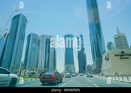 DOHA, QATAR - JULY 10, 2019; Wide-angle street and buildings in ultra-modern business district of Al Dafna with Qatar's king's image on building at st Stock Photo