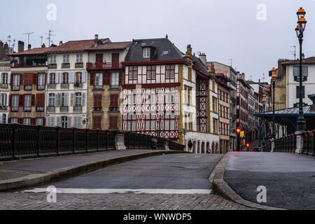 Bridge over Nive river in Bayonne with typical half timbered houses in the old town, France Stock Photo