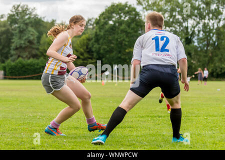 Amateur touch rugby player (female, 14-20 y) evades touch tackle from opponent Stock Photo