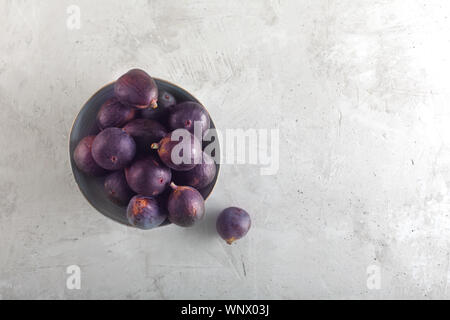 Fresh figs in a bowl on a gray wood background, top view with copy space Stock Photo