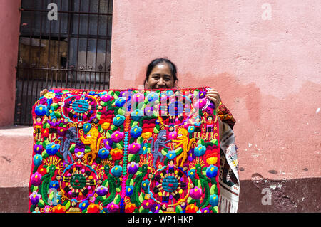 Mayan Woman Sells Textiles to Tourists at the Street Market in Chichicastenango, Guatemala