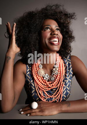 Smiling African American adult woman studio portrait on grey backgroun Stock Photo