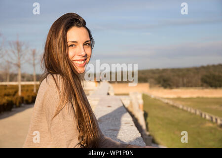 Portrait of young woman while leaning on stone Stock Photo