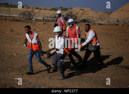 Gaza, Palestine. 06th Sep, 2019. Palestinian medics carry a wounded person during an anti-Israel demonstration at the Israel-Gaza border fence in the southern Gaza Strip. Credit: SOPA Images Limited/Alamy Live News