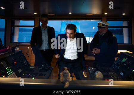 06 September 2019, Bavaria, Weßling: Markus Söder (CSU;m), Prime Minister of Bavaria, is standing on the bridge of the Seeshaupt during the navigation on the Starnberger See within the framework of the CSU board meeting on the bridge of the Seeshaupt next to Markus Blume, Secretary General of the CSU, and Günter Engel-Art, Captain of the Seeshaupt. Photo: Lino Mirgeler/dpa Stock Photo