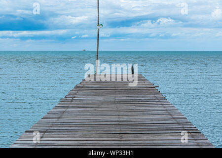 Wooden pathway end of the sea and blue sky background Stock Photo