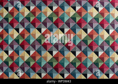 Geometric multicolored textile background pattern in a full frame view of diamond or square shapes with color shading Stock Photo