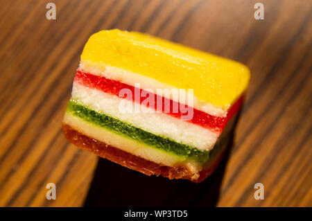 Dessert - marmalade in a multi-colored strip on a wooden background, a place for the text Stock Photo