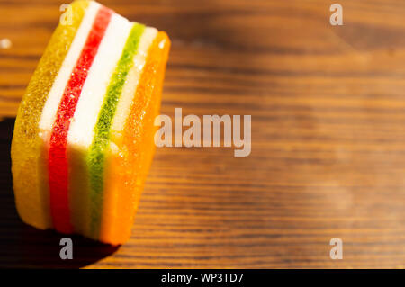 Dessert - marmalade in a multi-colored strip on a wooden background, a place for the text Stock Photo