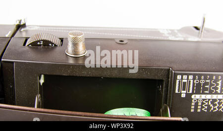 Modern electric sewing machine on a white background. Place for text. Stock Photo