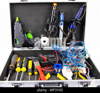 Aluminum case with a working tool on a white background - screwdrivers, pliers, soldering irons. Stock Photo