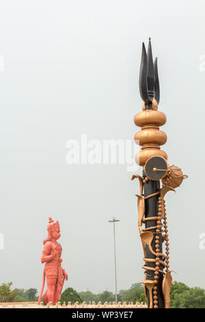 Statue of lord hanuman and trishul at a temple, Chhatarpur Temple, Chhatarpur, New Delhi, India Stock Photo