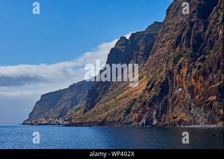 The southern coastline of the island of Madeira includes isolated villages at the foot of extensive sea cliffs.