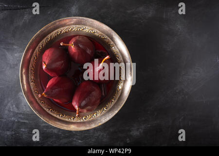 Poached pears in red wine with cinnamon and anise Stock Photo