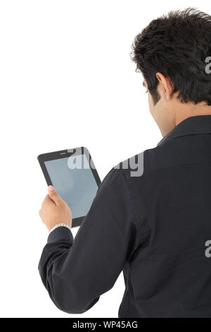 Rear view of a businessman using digital tablet Stock Photo