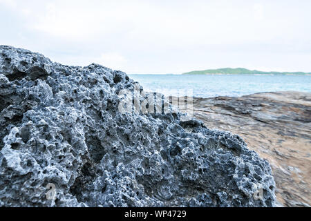 View of the rock beach at Khao Laem Ya–Mu Ko Samet National Park in the Gulf of Thailand off the coastline of Rayong, Thailand Stock Photo