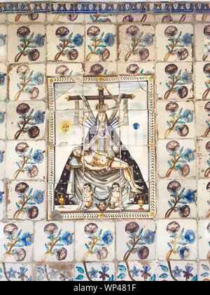 Detail of Spanish tiles in an outdoor public courtyard in Valencia, Spain, depicting the Virgen Mary,with swords in her heart, flowers, fruits Stock Photo