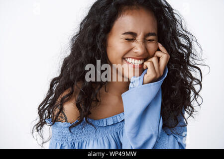 Happiness, wellbeing and emotions concept. Beautiful, charming curly-haired african american woman in elegant blue blouse, laughing joyfully, having f Stock Photo