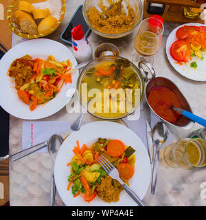 Typical Gomeran food Puchero de verduras (vegetble stew), gofio (toasted maize flour), almogrote (goat's cheese and paprika), salad, mojo (red canaria Stock Photo