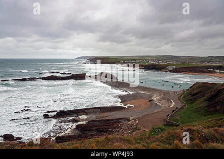 View from the clifftops at Bude, Cornwall’s most northerly town. Boats in Bude harbour protected by the breakwater. Stock Photo
