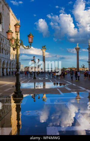 Tourists visit Saint Mark Square in Venice just after high tide flooding Stock Photo