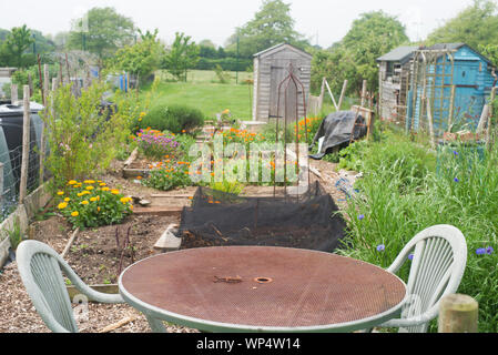 Table and chairs on an allotment Stock Photo