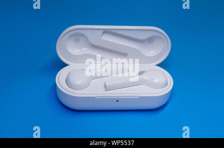 Wireless Bluetooth Earphone or Ear bud. Air Pods wireless Bluetooth headphones. Stock Photo