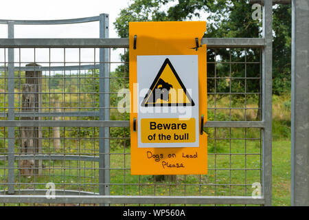 Beware of the bull sign signage on a gate Stock Photo