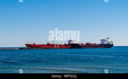 MISSISSAUGA, CANADA - OCTOBER 10, 2016: Two tanker ships are docked at the Suncor Energy lubricants plant on the northern shore of Lake Ontario. Stock Photo