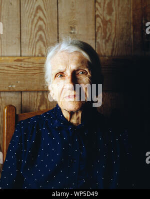 Kate Carter, on her 90th birthday, poses in the log cabins where photographer Carol M. Highsmith's great-grandfather, Pleasant Jiles Carter (1847-1931) and grandfather, Yancey Ligon Carter (1873-1947) were born and lived in Wentworth, North Carolina Stock Photo