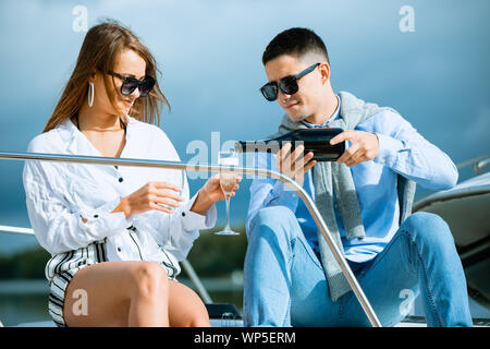 Two young tourists having fun on boat tour in the summertime Stock Photo