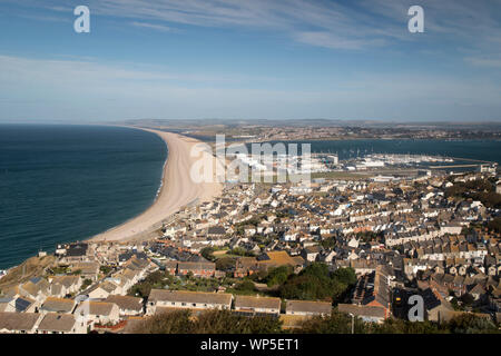 Jurassic coastline showing Chesil Beach and the Weymouth and Portland National Sailing Academy from the summit of the Isle of Portland Stock Photo