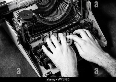 Hands writing on old typewriter Stock Photo