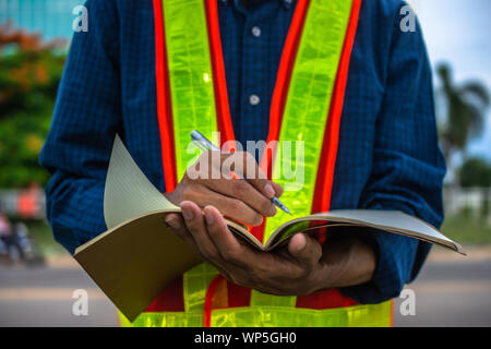 Engineer write take note on book for planing work Stock Photo