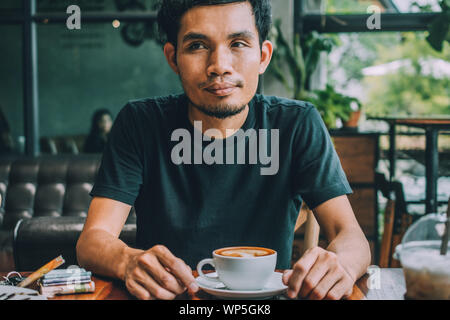 Man sitting in coffee shop for drink in coffee time Stock Photo