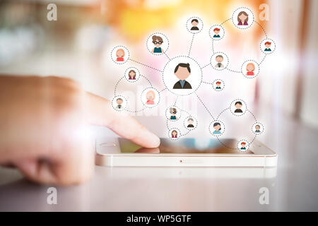 Woman's hand touching on communication digital smartphone. Technology with flat people icon on mobile screen. Stock Photo