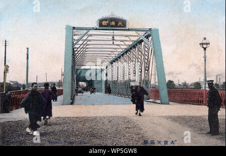 [ 1910s Japan - 70219-0002 - Tenmabashi Steel Bridge in Osaka ] —   Temmabashi Bridge, Osaka.  The bridge was, together with Tenjinbashi and Naniwabashi, considered to be one of the Three Large Bridges of Naniwa (浪華の三大橋). Naniwa is the historical name for Osaka.  The original wooden bridge was washed away by floods in July, 1885 (Meiji 18) and replaced by the steel bridge shown in this photograph in 1888 (Meiji 21).  In 1935 (Showa 10), this bridge was replaced. The current Tenmabashi dates from 1970 (Showa 45).  20th century vintage postcard. Stock Photo