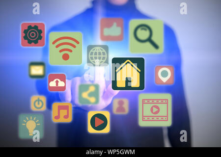 Close up of young man touching icon of media screen. Multimedia and technology concept. Stock Photo