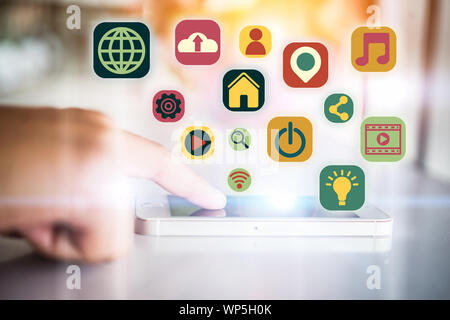 Finger touching on martphone with network and communication flat icons. Technology digital community concept. Stock Photo