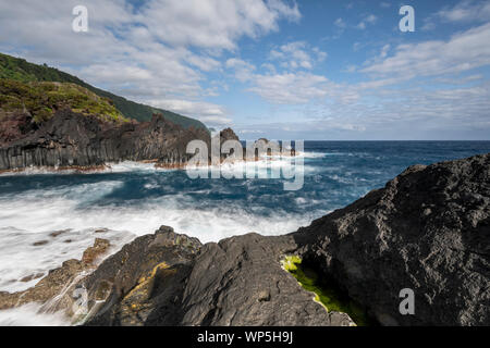 sunlight over the landscape at the Piscina Natural de Poça Simão Dias at the village of Fajã do Ouvidor, one of the most remarkable natural pools and Stock Photo