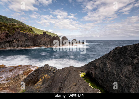 sunlight over the landscape at the Piscina Natural de Poça Simão Dias at the village of Fajã do Ouvidor, one of the most remarkable natural pools and Stock Photo