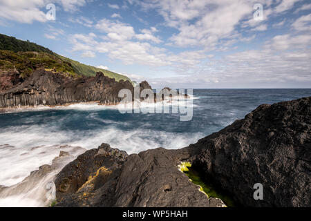 sunlight over the landscape at the Piscina Natural de Poça Simão Dias at the village of Fajã do Ouvidor, one of the most remarkable natural pools and Stock Photo