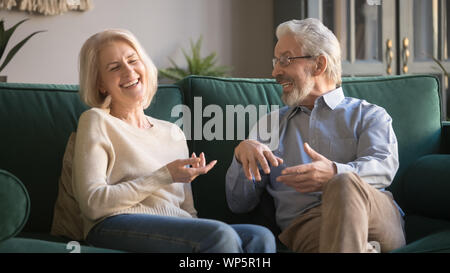 Excited happy family couple spending time together, laughing and joking. Stock Photo