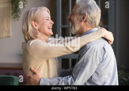 Happy senior couple relax dancing at home together Stock Photo