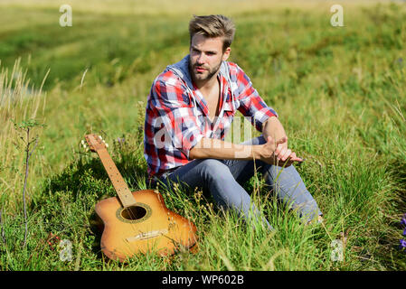 Wanderlust concept. Summer vacation highlands nature. Peaceful mood. Guy with guitar contemplate nature. Inspiring nature. Pleasant time alone. Musician looking for inspiration. Dreamy wanderer. Stock Photo