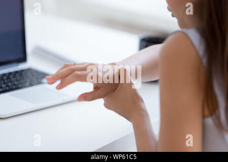 Hurt woman worker massage wrist suffering from spasm Stock Photo