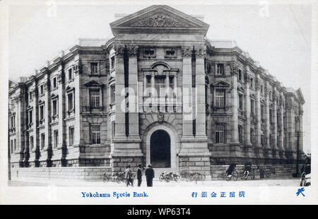 [ 1920s Japan - Yokohama Specie Bank ] —   Yokohama Shokin Ginko (横浜正金銀行, Yokohama Specie Bank) located on Bashamichi-dori in Yokohama, Kanagawa Prefecture.  Founded in 1880, the Yokohama Specie Bank played a very important role in Japanese trade with China. It became The Bank of Tokyo, Ltd. in 1947.  The building on this image was designed by Japanese architect Yorinaka Tsumaki (妻木頼黄, 1859-1916). It survived the Great Kanto Earthquake of 1923.  20th century vintage postcard. Stock Photo