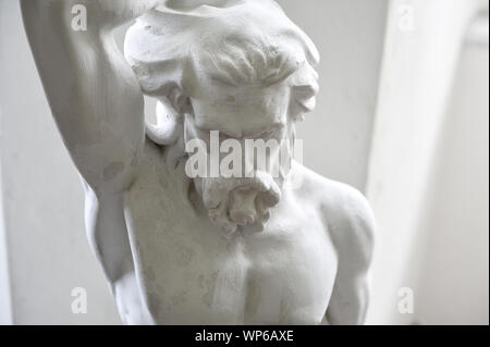 Head and shoulders detail of ancient sculpture of man Stock Photo