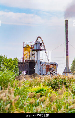 Plant with a chimney on the nature. Industrial landscape. Stock Photo